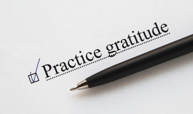 A piece of paper with the inscription practice gratitude from to do list with a tick
